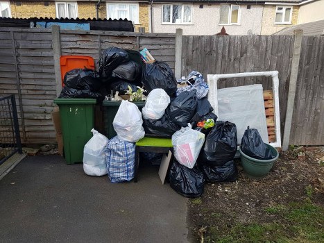 Fridge disposal team removing a large domestic appliance from a London property
