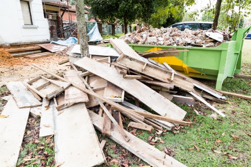 Waste removal van loading mixed rubbish from a London home