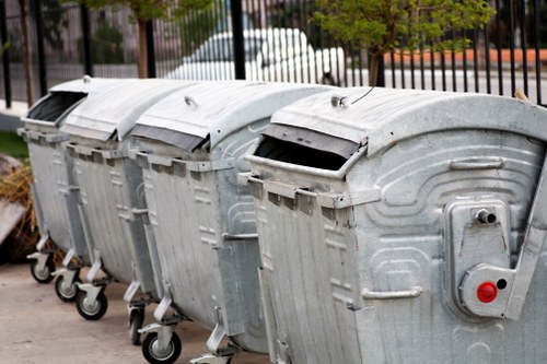Rubbish removal worker handling waste safely with protective equipment